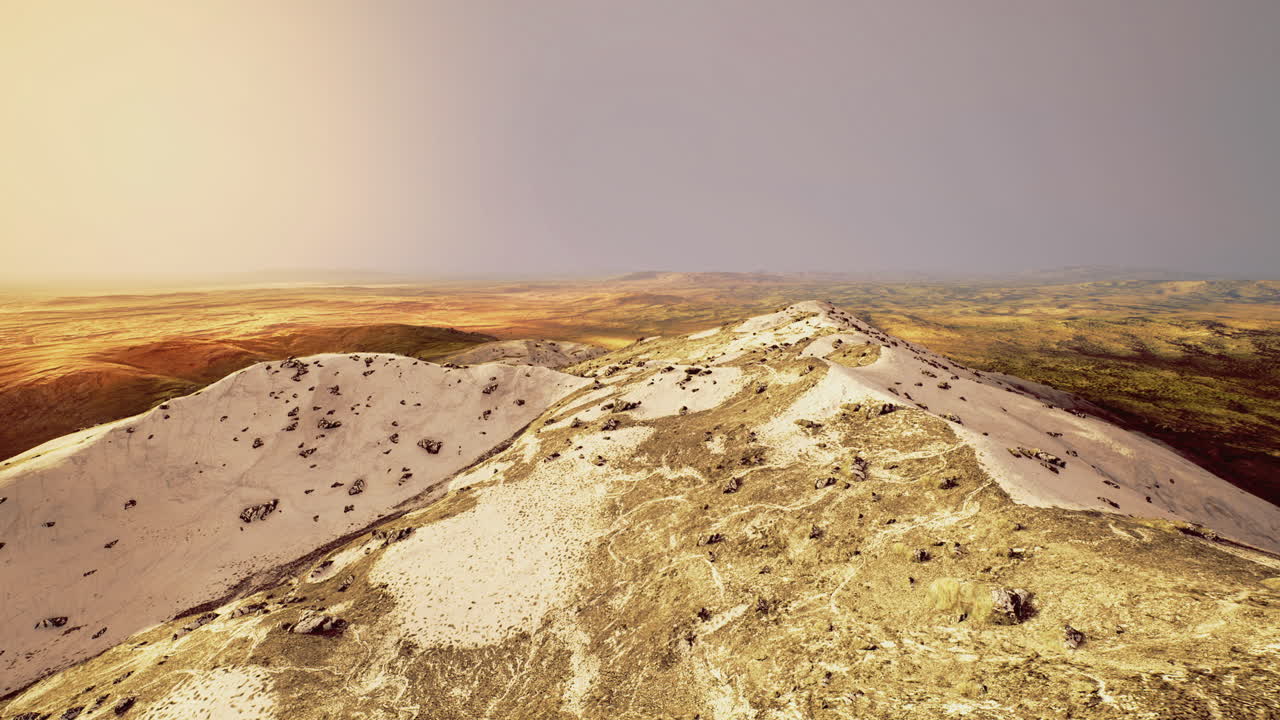 Exploring a desert with rolling dunes and hills at sunset