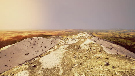 exploring a desert with rolling dunes and hills at sunset
