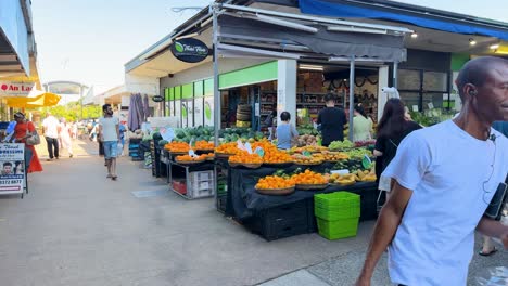 shoppers explore vibrant fruit and vegetable stalls