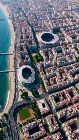 aerial view of barcelona cityscape with stadium and coastal area