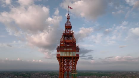 blackpool tower top and observation deck against golden hour sky with slow orbit. lancashire, uk.