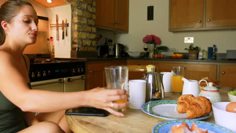 woman having food on dining table in kitchen 4k