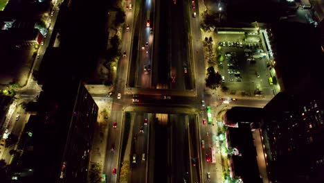 aerial view looking down over illuminated santiago, chile traffic moving through metropolitan high rise city streets