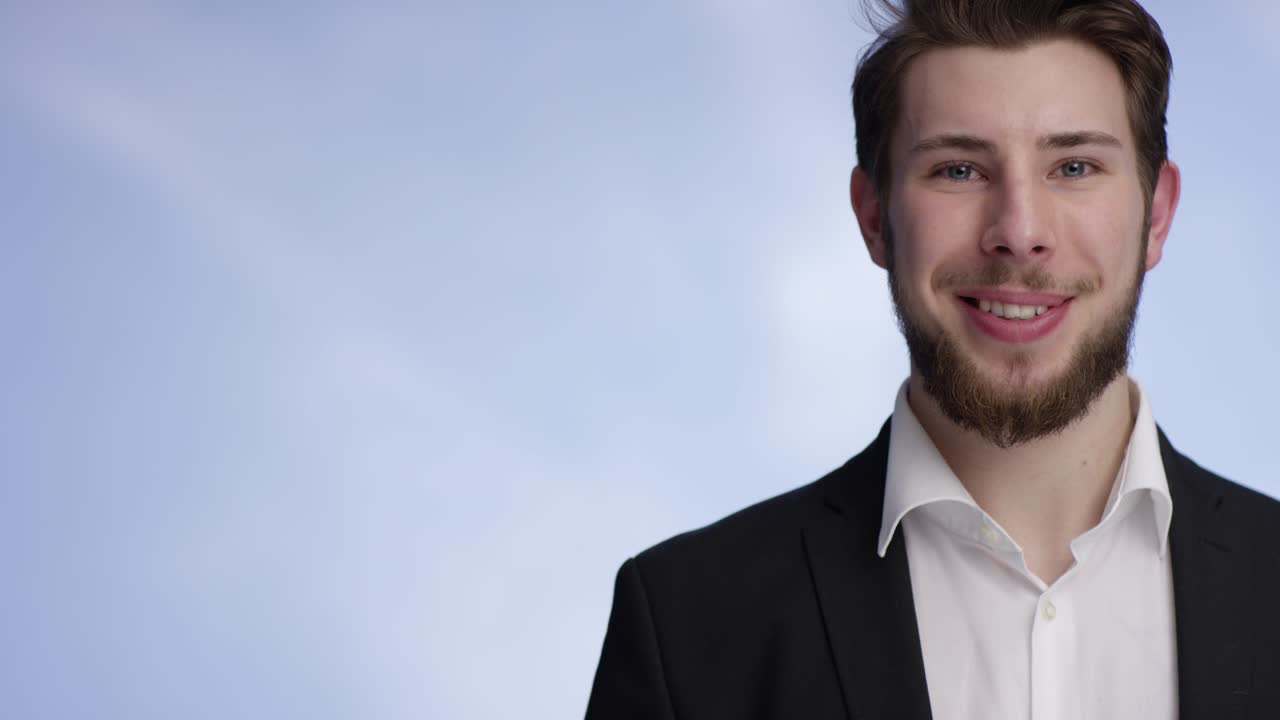 Young and attractive man smiling and raising a buisness card into the camera