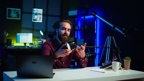 close up shot of futuristic vr goggles held by man reviewing them for viewers