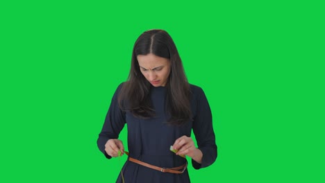 Sad-Indian-girl-measuring-her-waist-Green-screen