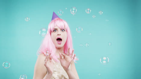 Crazy-face-pink-hair-woman-dancing-in-bubble-shower-slow-motion-photo-booth-blue-background