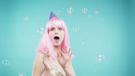 crazy face pink hair woman dancing in bubble shower slow motion photo booth blue background