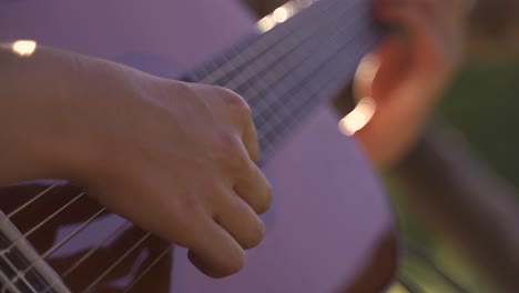 4k young female kindly playing guitar outdoors daylight sunset closeup