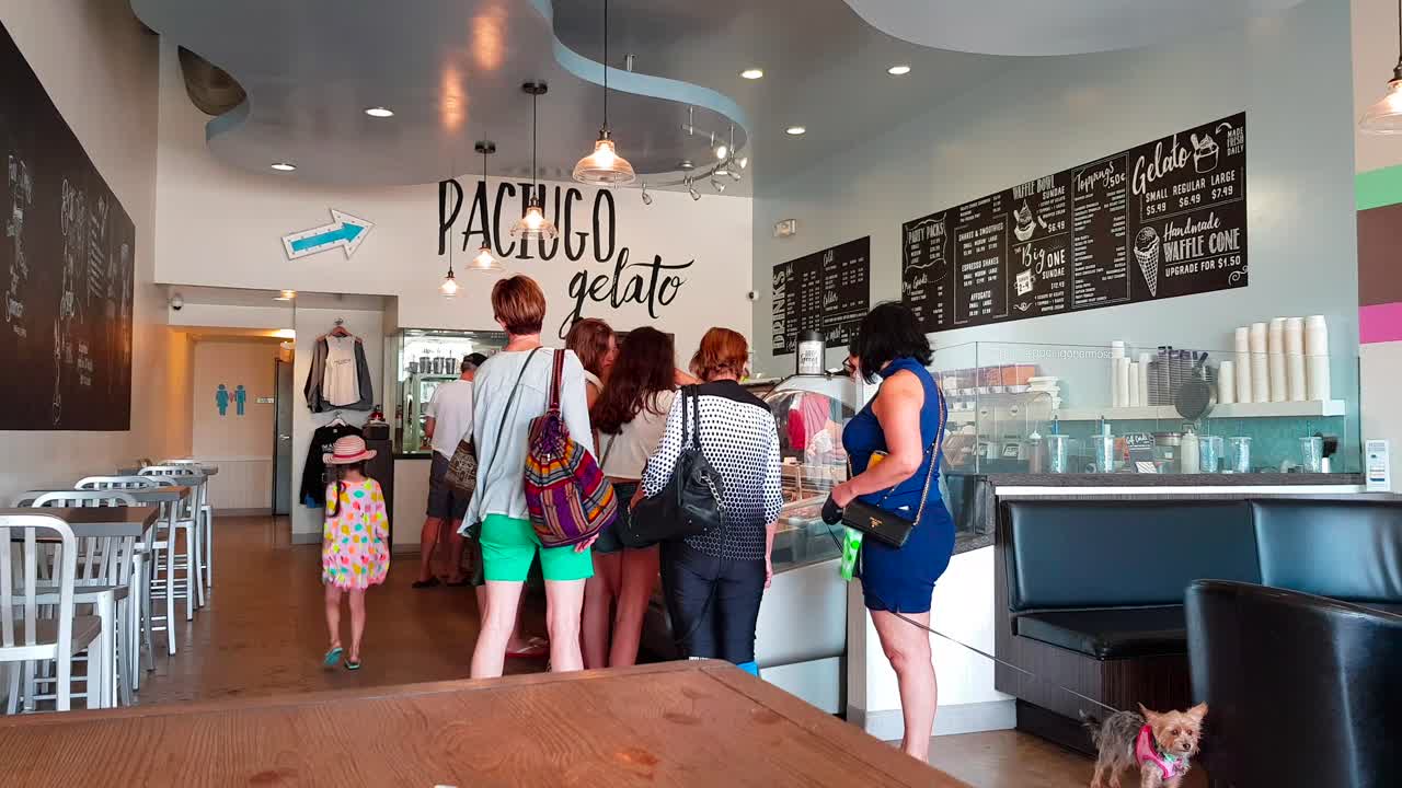 People queuing up at ice cream parlor at Hermosa Beach, LA, California USA on a hot summer day