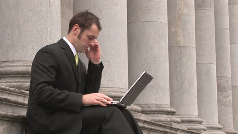 Business-man-Outdoors-Using-Laptop