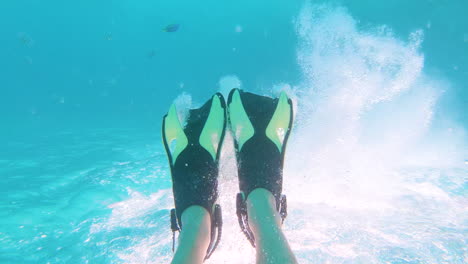 diver swimming with flippers, making lots of bubbles, point of view