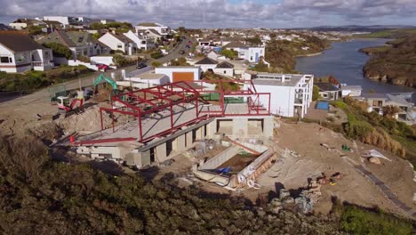 aerial shot steel frame construction overlooking seaside in cornwall 5