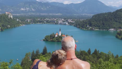 a romantic elderly couple enjoying the view of lake bled in slovenia