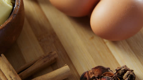 Various-ingredients-and-brown-eggs-on-wooden-table-4k