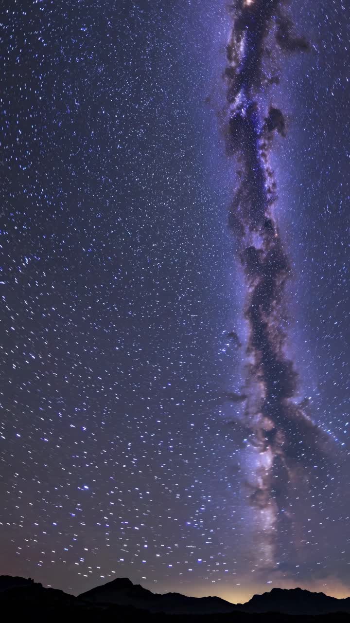 Vertical video capturing the Milky Way's splendor in a starry night sky, shot from a low angle