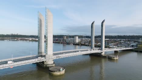 jacques chaban delmas bridge with vehicle traffic over the garonne river in bordeaux france, aerial orbit side view