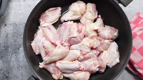 raw chicken wings in a pan