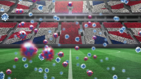 animation of covid 19 cells over british flag in empty sports stadium