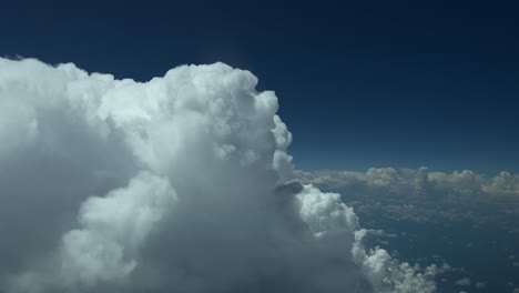 Close-up-view-of-the-top-of-a-huge-cumulonimbus-viewed-from-a-jet-cabin-flying-at-12000m-high