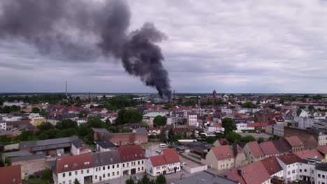 kothen germany, building burning in distance with big black smoke