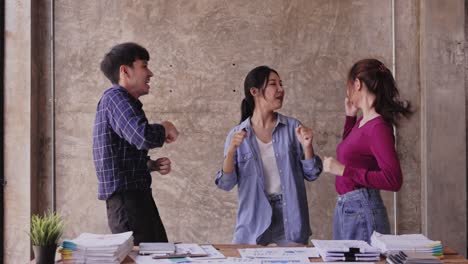 Young businessman excited about achieving sales goals. standing and dancing happily