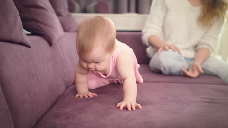 Little-baby-crawling-on-home-sofa.-Cute-kid-walking-on-all-fours