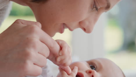 mother kissing happy baby laughing enjoying loving mom nurturing toddler at home 4k