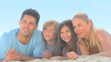 Cute-family-watching-someone-on-a-beach