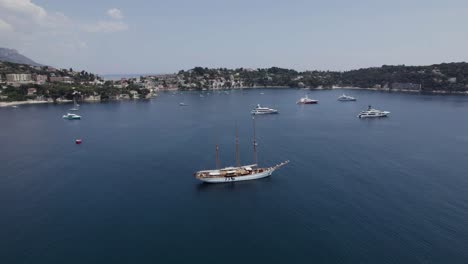 Massive,-Luxury-Barque-Sailing-Yacht-on-French-Riviera-Mediterranean-Coastline-in-France,-Aerial