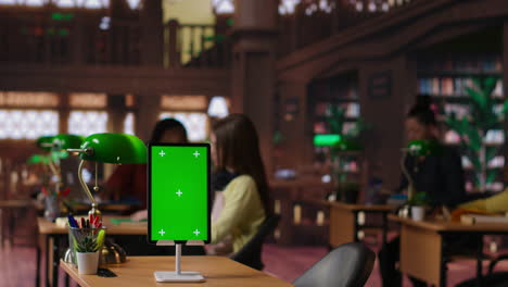 students in a library classroom with green screen tablet