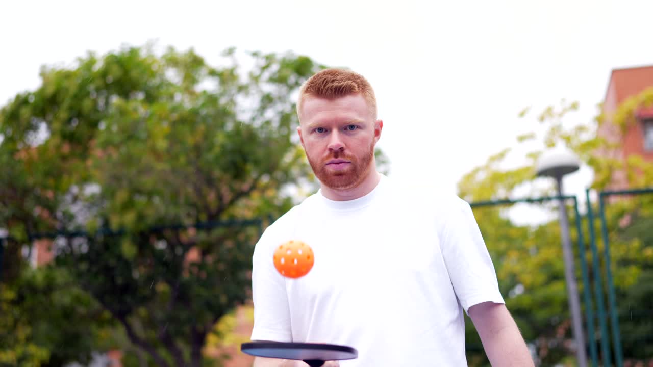 Man playing pickleball outdoors