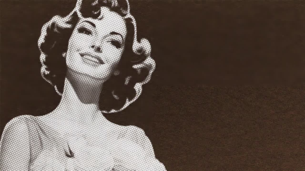 Vintage video still of a woman with retro curls, captured in a low-angle shot