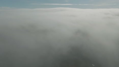 drone flight above thick layer of clouds above magdalen islands in quebec