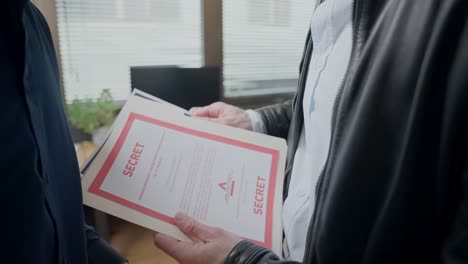 man pulls out a confidential paper from a secret folder and discreetly hands it over. subtle exchange and intentional, secrecy, trust, covert communication. classified information, investigations.