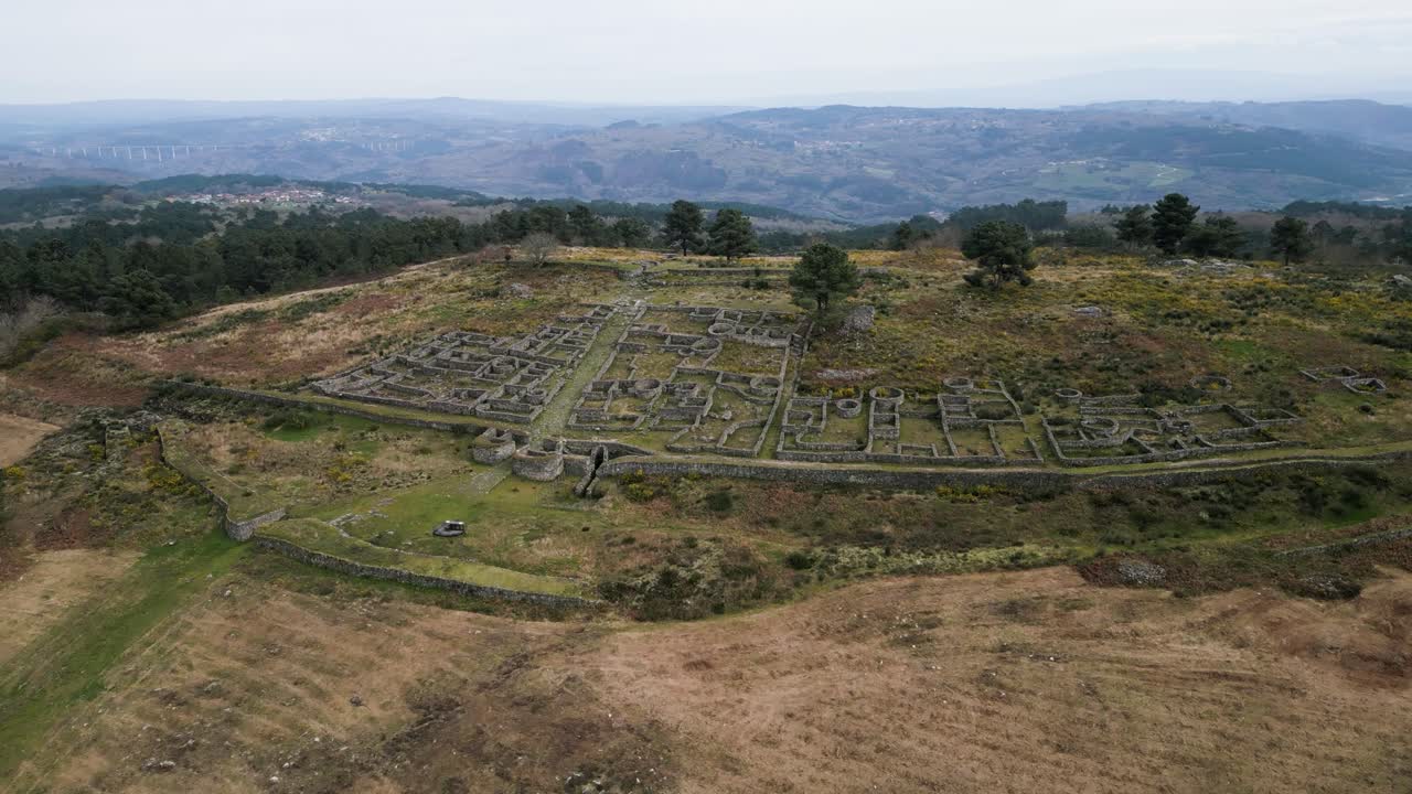 Un drone si alza lentamente sopra Castro de San Cibran a Ourense, Spagna, per rivelare una vasta valle.