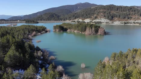 Aerial-view-Aoos-spring-lake-islets-Mountain-Forest-trees-sunny-day