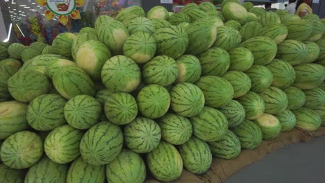 heap of ripe exotic indian watermelon for sale at the market