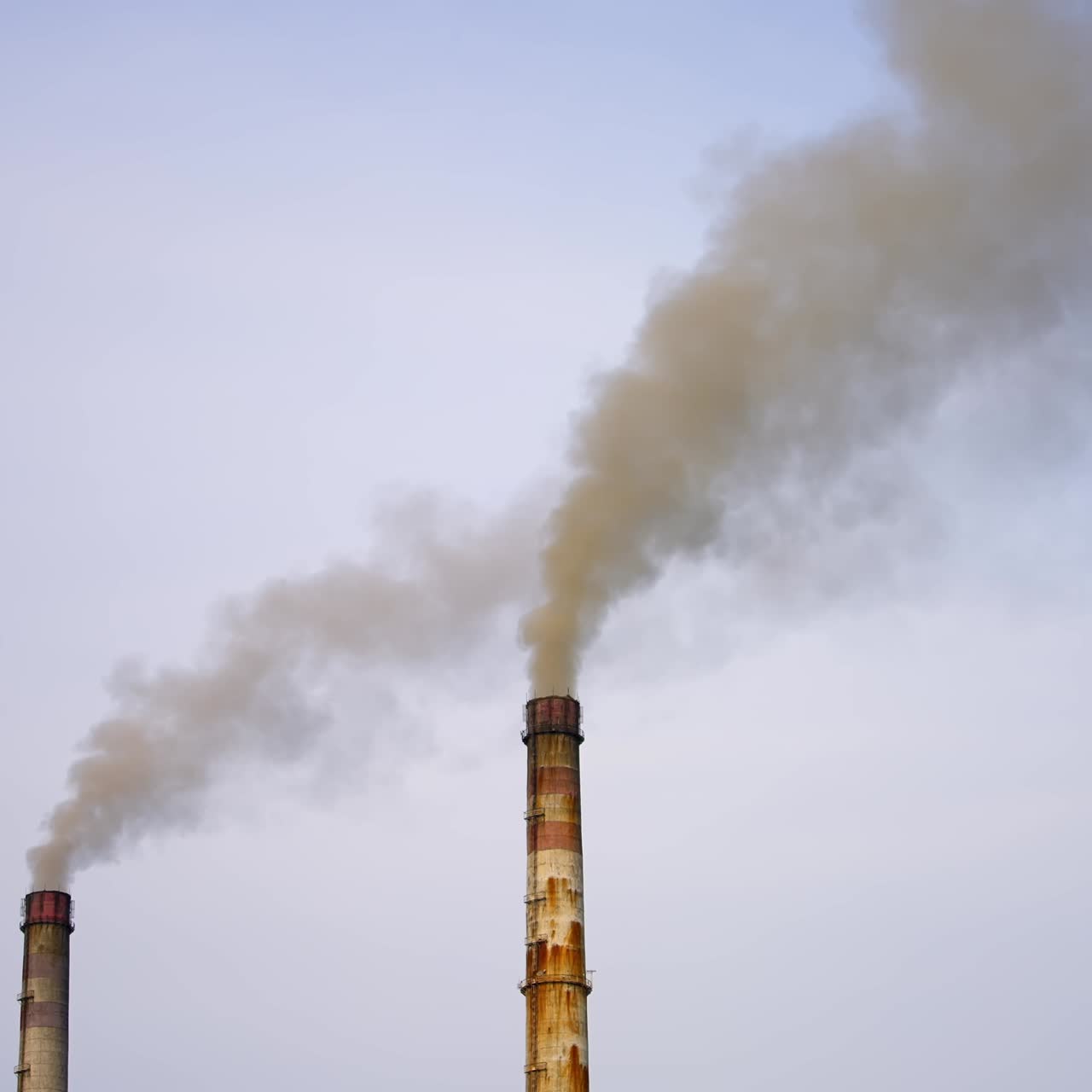 Industrial chimneys with gas and smoke. Towers with vapor from metallurgical industrial factory. Poisoned air. Pollution of nature. Toxic substances