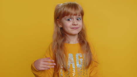 smiling young girl with red hair in a yellow sweatshirt