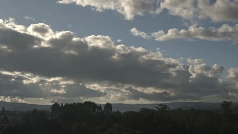 1 minute timelapse of cumulus clouds forming and dispersing over a pine forest in galicia