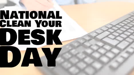 animation of national clean your desk day text over hand of caucasian businesswoman writing