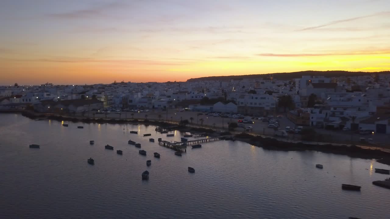 Aerial view of the small white fishing town of Barbate in Cadiz, Andalusia, during the sunset.