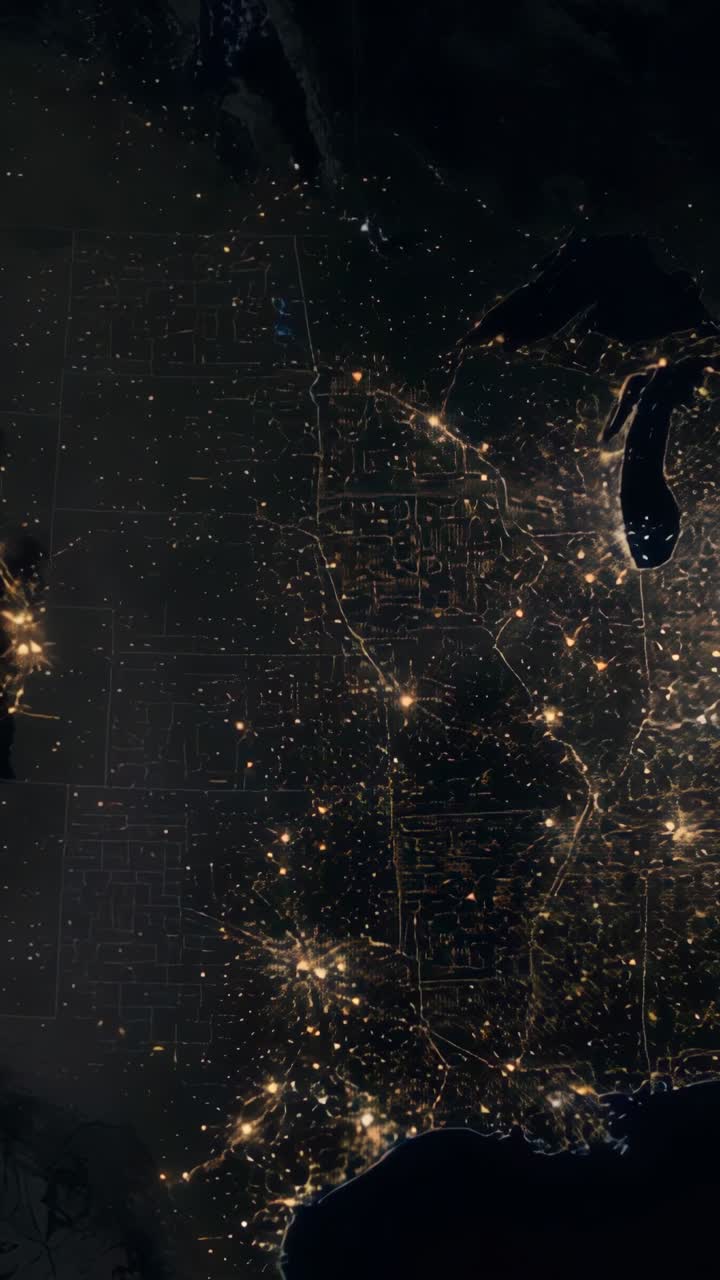 Vertical video: Nighttime US satellite view showing drifting clouds veiling Great Lakes city lights