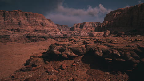 dramatic landscape of rugged rock formations under a cloudy sky at dusk