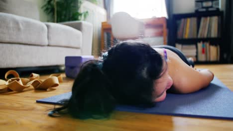 Woman practicing yoga in living room