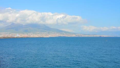 beautiful view of the mediterranean sea with crystal clear blue water and mount vesuvius in the background filmed from naples, italy