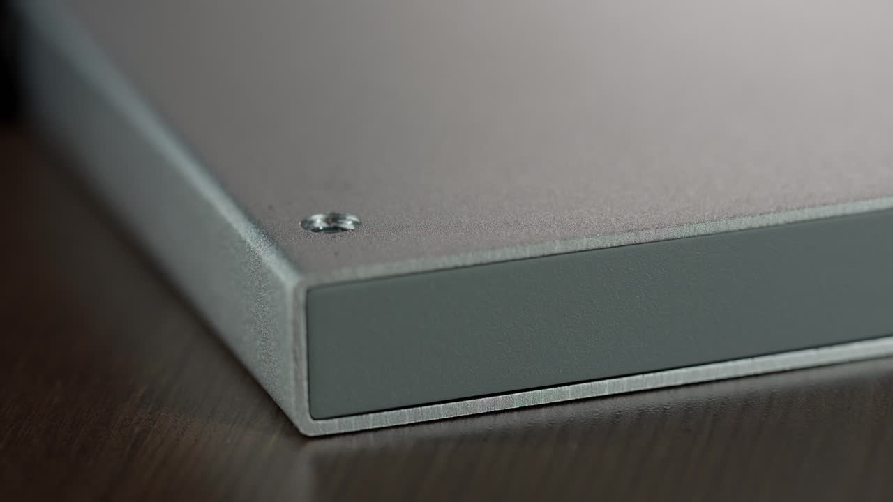 Automatic screwdriver removing a star-shaped screw from a hard drive casing, highlighting hardware repair and data storage maintenance