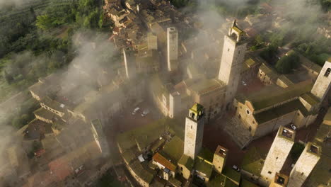 Fog-Over-San-Gimignano-Town-In-Tuscany,-Italy---aerial-drone-shot