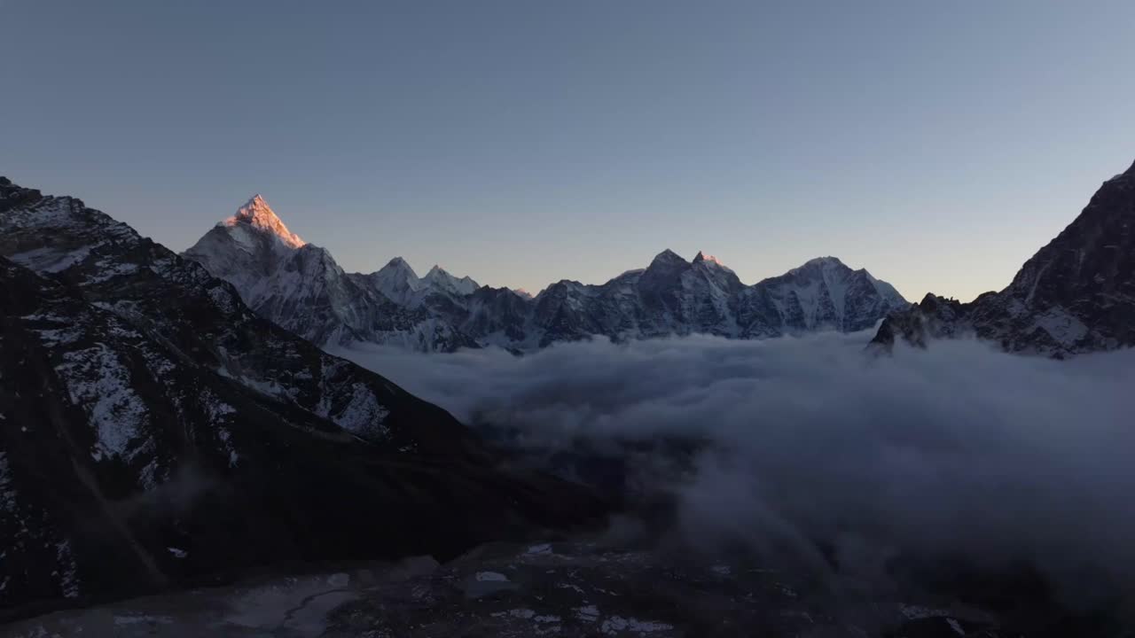 Majestic sunrise over Himalayan mountains with clouds below